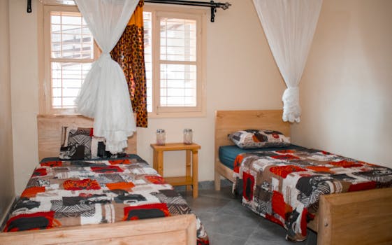 Inviting twin bedroom in Kampala, featuring vibrant bedspreads and a peaceful ambiance.
