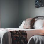 Inviting hotel room interior with a neatly arranged bed and soft lighting.